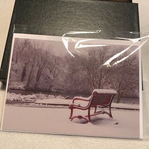 Card of red bench in the snow.